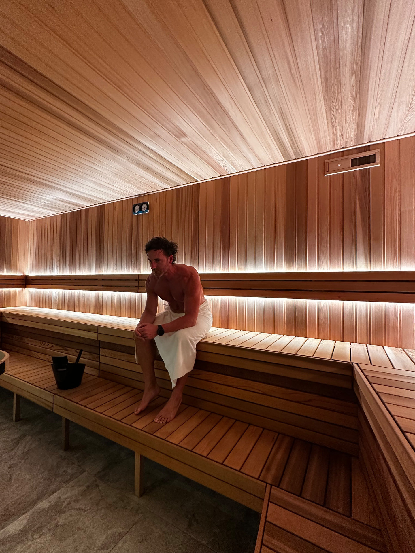 Jordan sitting in a cedar sauna